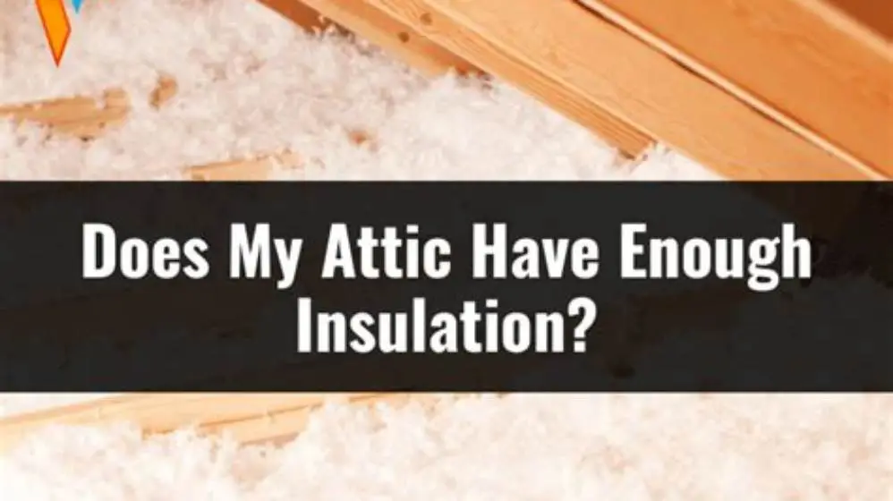 attic insulation being installed with a measuring tape